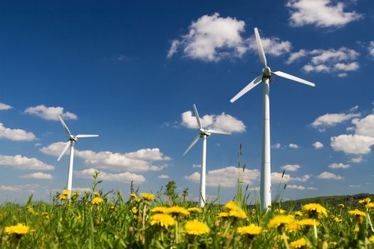 Wind Turbines against blue sky with small clouds