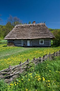 Polish old house with wooden fence in front