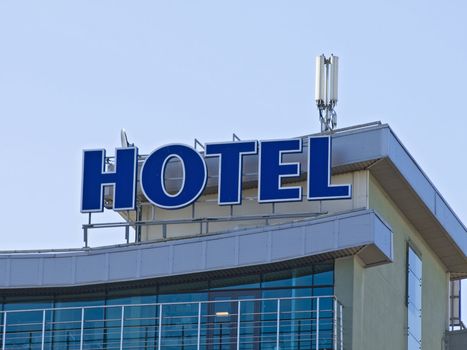 Hotel signs at the building against the blue sky