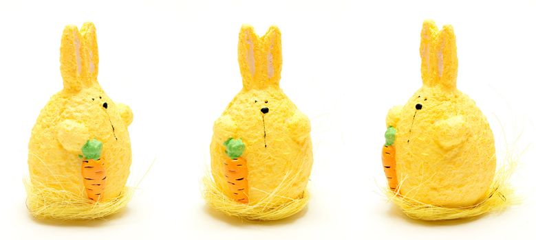 Stuffed bunny with carrot over white background