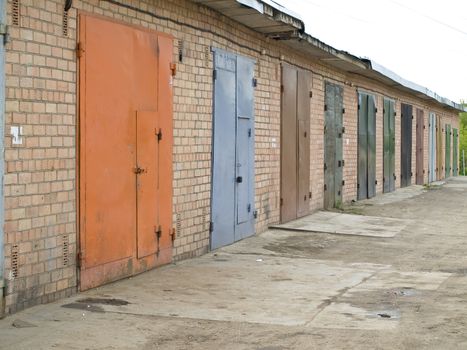 row of garage with multicolored metalic doors