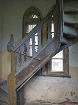 Old spiral stairs in tower wih arch windows