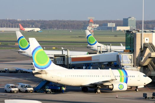 An overview of a major airport, several planes waiting on the gates