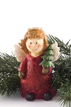 Modern angel in front of a christmas tree branch, isolated on white.