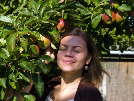 Young attractive woman enjoy apples blossom tree