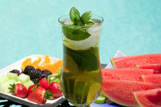 Ice tea, fruits (melon, watermelon, blackberry, kiwi, orange, strawberry)