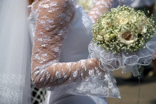 Wedding bouquet in a hand of the bride