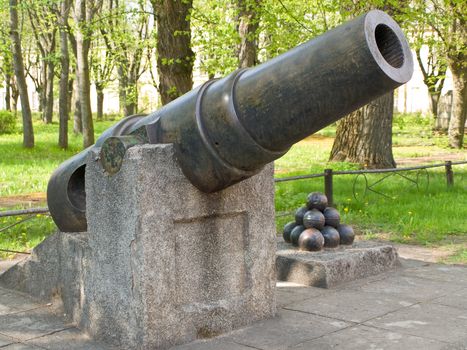 old canon with canon balls at the city park