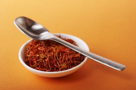 Dried saffron on the white bowl with spoon
