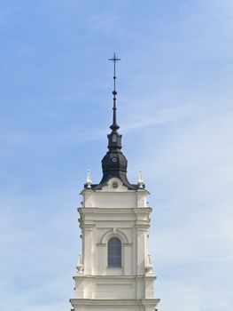 Church tower against the blue cloudy sky 