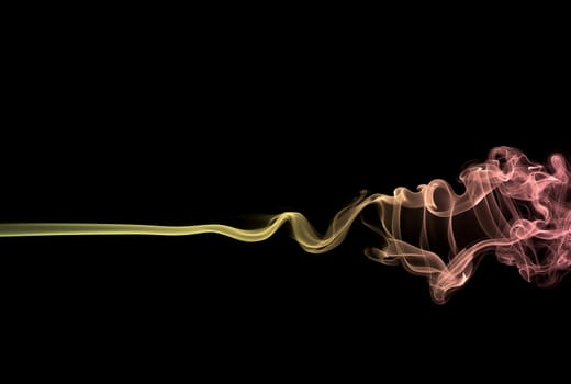 Abstract colored (yellow/red) smoke on black background