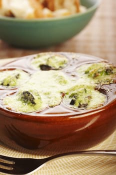 Cooked snail with garlic and butter on the table