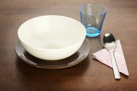 empty soup plate over a dark wooden table