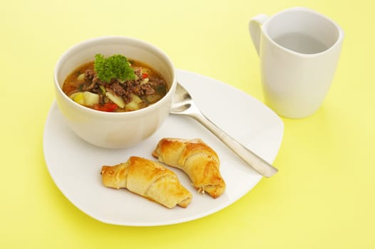 Lunch soup (vegetables and grounded meat) and baked cheese rolls