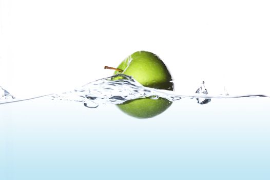 Isolated green apple surfing on the wave