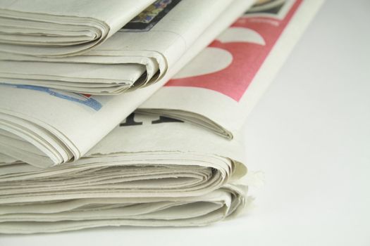 pile of daily newspapers isolated over a white background