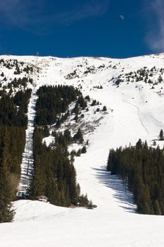 Red piste and chairlift in Meribel Valley, French Alps