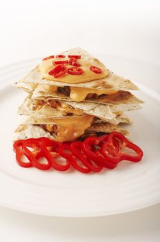 Mexican tortilla tower with cheddar and red chili peppers