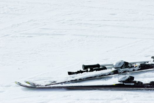 Skis and poles on a snow at ski resort