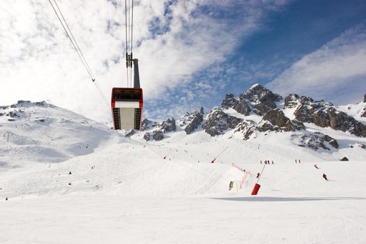 Aerial tramway under the piste at Courchevel ski resort, French Alps