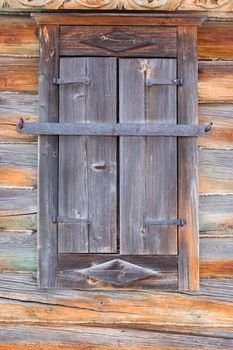 Rustic wooden window closed with shutters