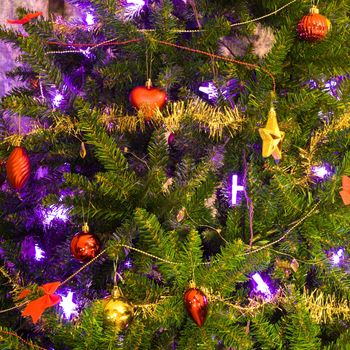 Lighted with purple lights decorated Christmas tree