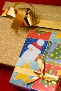 Gift boxes with golden ribbon on red