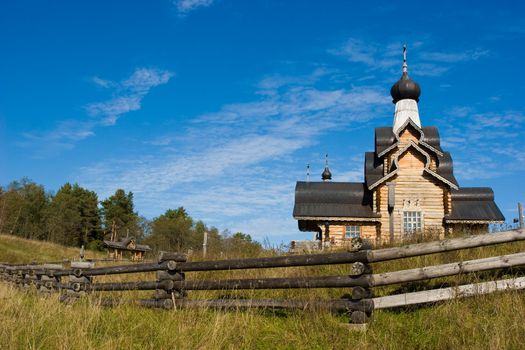 Wooden church behind log fence at Seliger lake, Russia