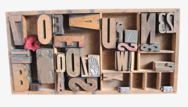 an arrangement of wood type and numbers in various sizes with metal printer's cuts