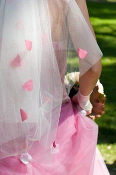 Bride holding wedding bouquet at sunny day