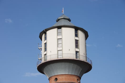 Autumn. An old tower for a pressure of water and it's roof in clear, without cloudy day.