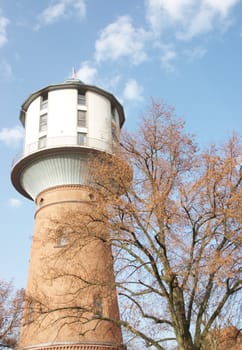 Autumn. An old tower for a pressure of water. Germany. Nauen
