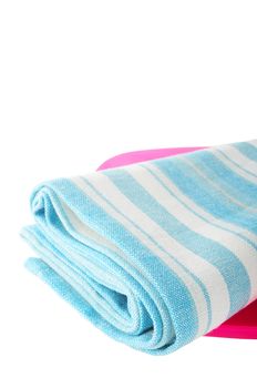 Isolated white towel with blue grid on the pink plastic plate.