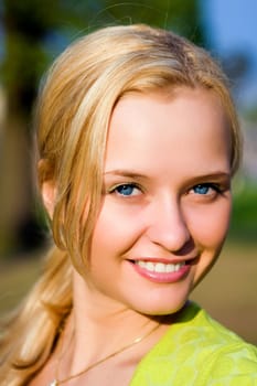 Portrait of the beautiful girl in beams of the coming sun