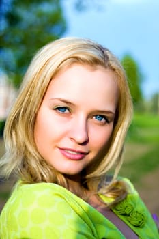 Portrait of the beautiful girl in beams of the coming sun