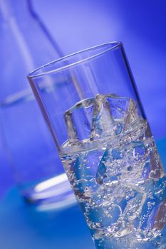 Glass of sparkling water glass with ice cubes