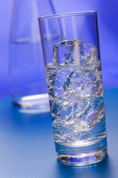 Glass of sparkling water glass with ice cubes