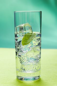 Glass of sparkling water glass with ice cubes