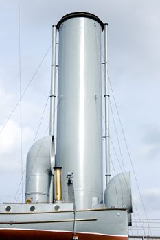 Ship funnels and boat close up with a sky in a background