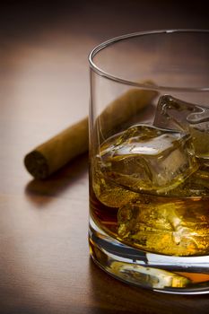 Whisky glass with havanna cigar on the table