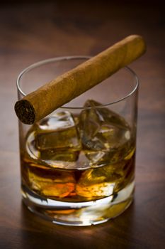 Whisky glass with havanna cigar on the table