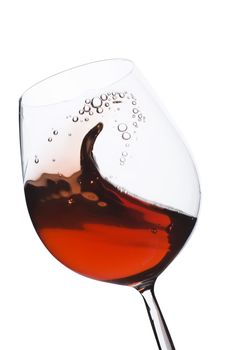 Isolated moving (motion blur) red wine glass over a white background