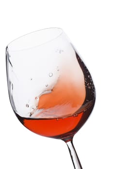 Isolated and moving red wine glass over a white background