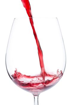 Pouring red wine into to the glass