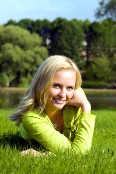 The girl lays on a grass a meadow