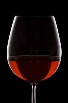 Isolated red wine glass over a black background