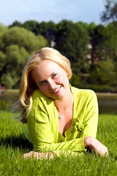 The girl lays on a grass a meadow