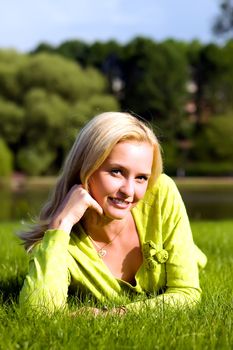 The girl lays on a grass a meadow