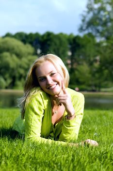 The girl lays on a grass a meadow