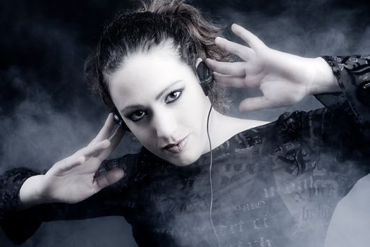 Portrait of a woman with long curly hair enjoying music on her headphones